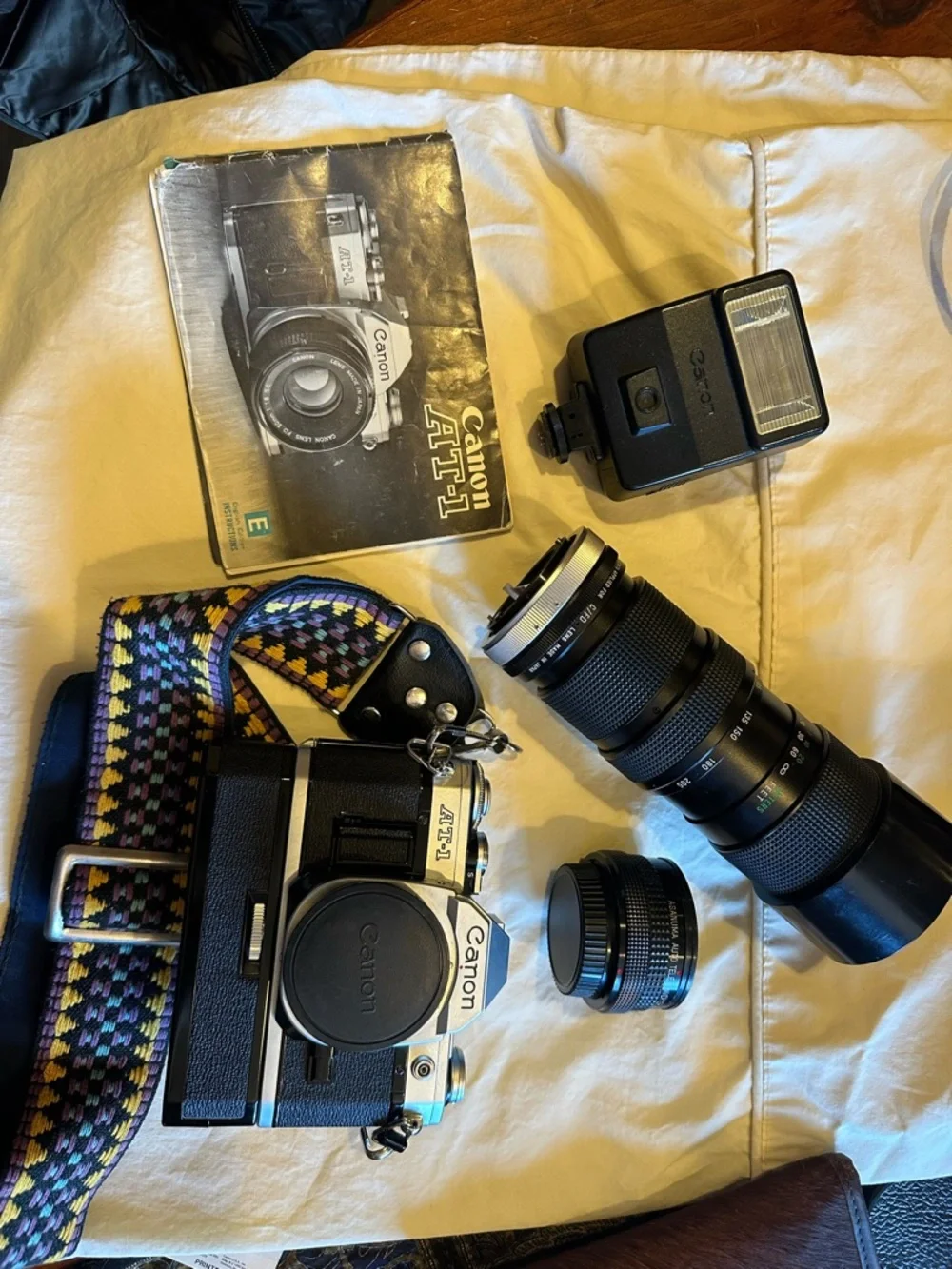 Canon AT-1 35mm SLR Camera with Black Body and Multicolor Woven Strap